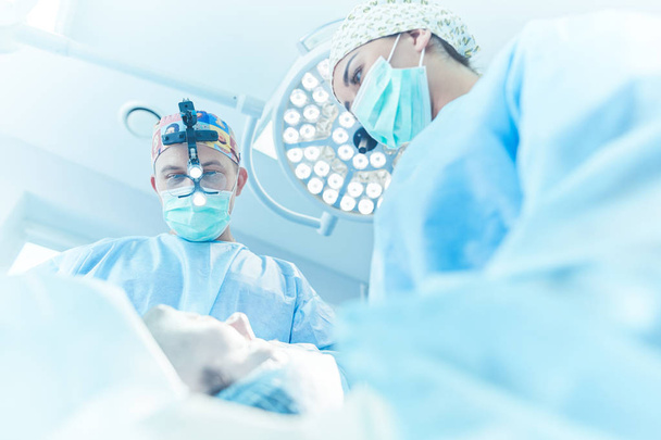 Man surgeon at work in operating room - Fotó, kép