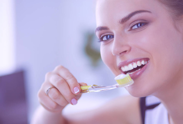 Young pretty girl maintaining oral hygiene with toothbrush. - Photo, Image