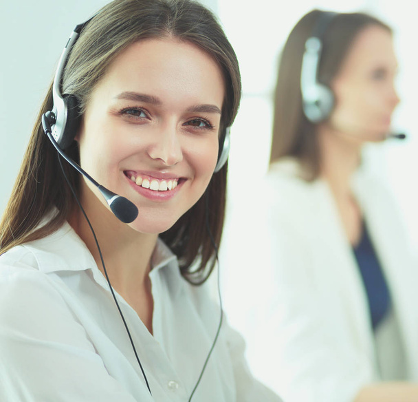 Smiling businesswoman or helpline operator with headset and computer at office - Fotografie, Obrázek