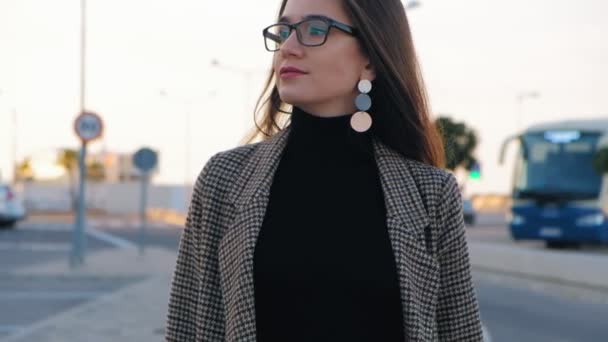 Slow motion of young business woman in glasses walking confidently along the street. Stylish woman walking on a sunny day. - Záběry, video