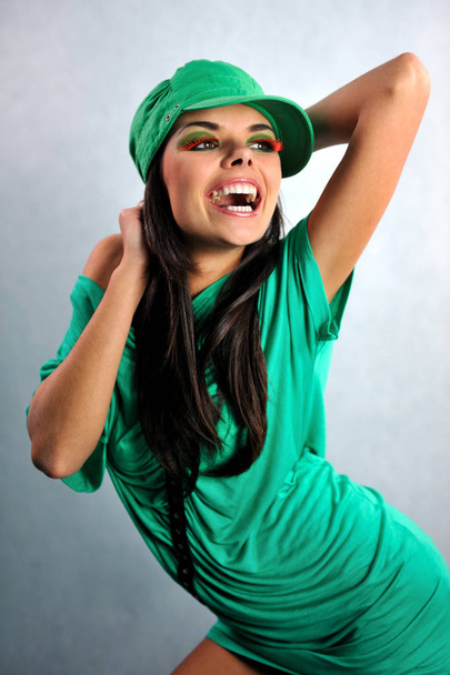 smiling girl posing in a green dress with glasses - Zdjęcie, obraz