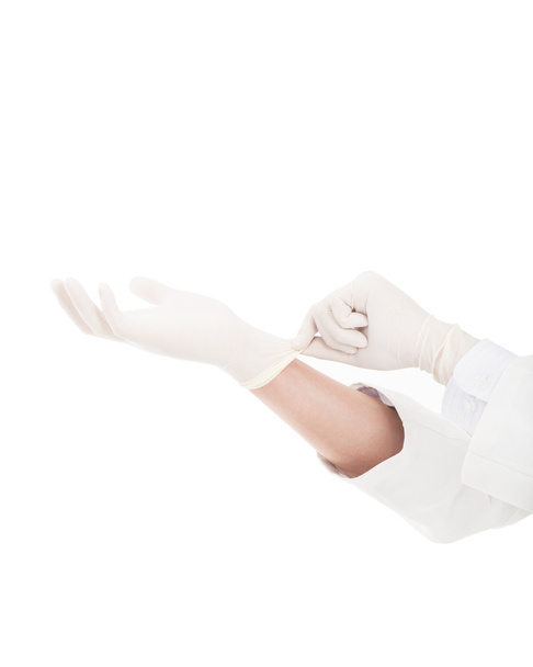main du médecin tirant sur des gants chirurgicaux blancs
 - Photo, image