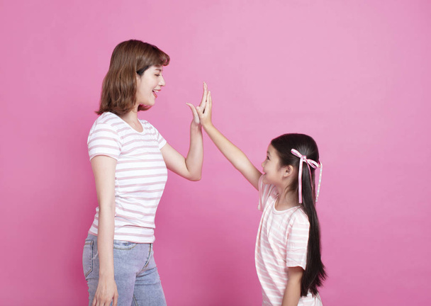 mother and daughter making hi five gesture - Photo, Image