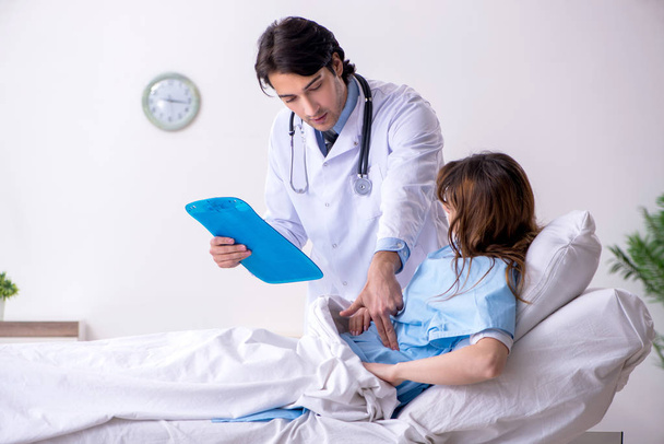 Male doctor visiting female patient in ward  - Photo, image
