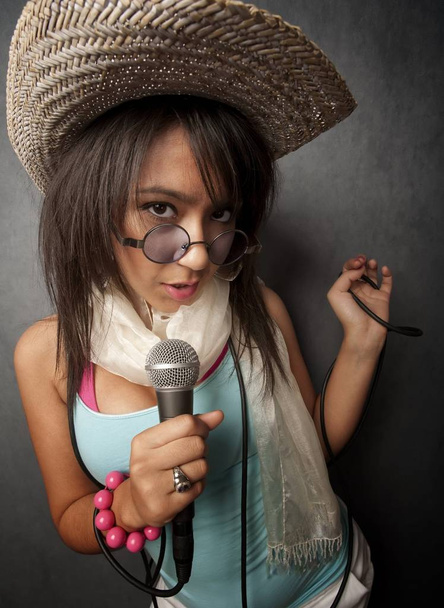 Pretty young singer with a large microphone - Foto, imagen