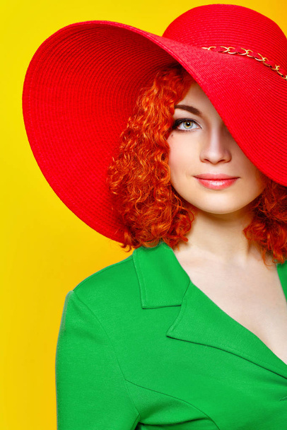 Attractive red-haired girl in red shady hat shot closeup - Valokuva, kuva