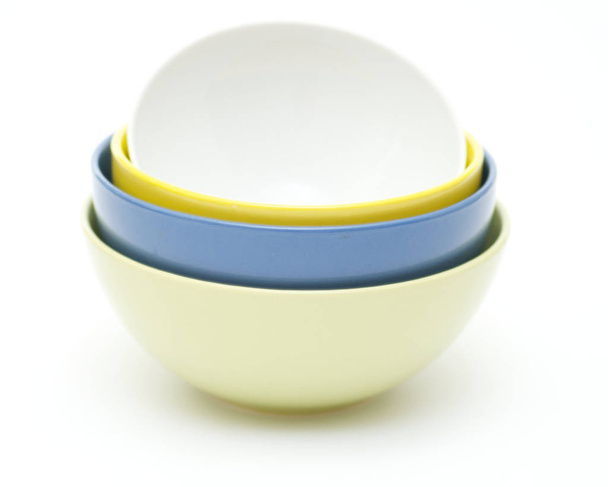 Green, blue, yellow and white plates on white background - Foto, Imagen