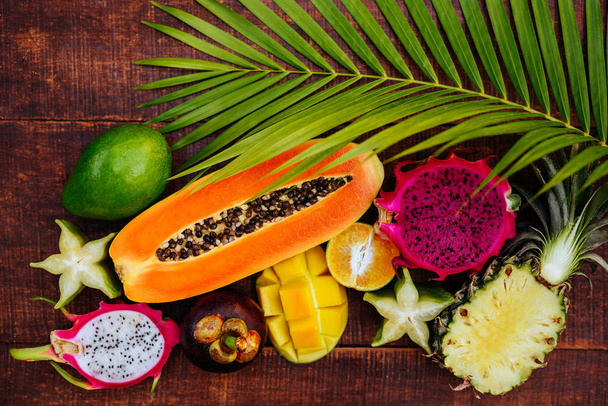 Tropical fruits on wooden background - Foto, Imagem