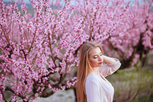 portrait of young lovely woman in spring flowers - Foto, immagini