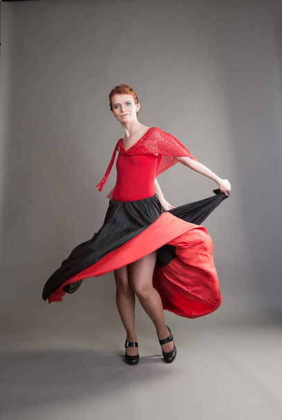 flamenco dancer swinging skirt on a grey background - Foto, immagini