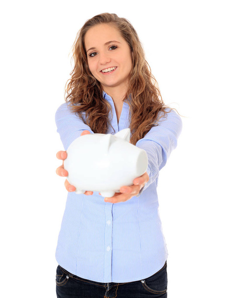Attractive young girl holding piggy bank. All on white background. - Photo, Image