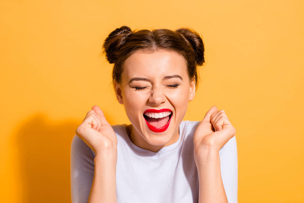 Close-up portrait of her she nice attractive fascinating lovely cheerful cheery crazy glam girl holding fists hope luck great success isolated over bright vivid shine yellow background - Fotografie, Obrázek