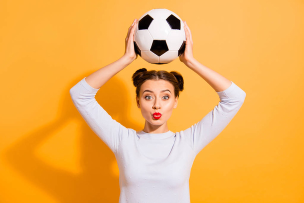 Close up photo beautiful hairdo she her lady judge referee hold raise above head hands arms leather ball send kisses players love work job wear casual white pullover isolated yellow background - Foto, immagini