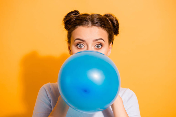 Close up photo of cute lovely hipster party maker preparing festive surprise for her boyfriend friends putting lips to inflate balloon wearing white sweater isolated on vivid background - Photo, image