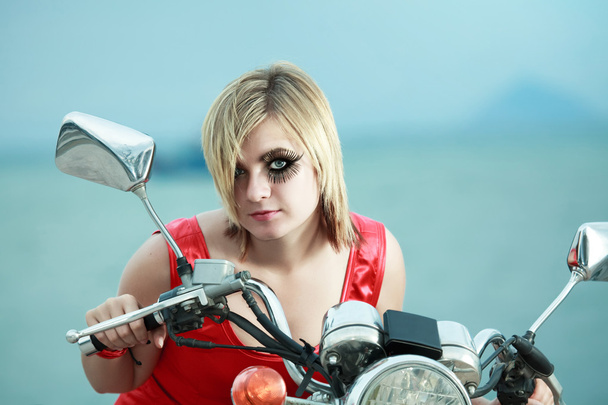 Woman with a motorcycle - Фото, изображение
