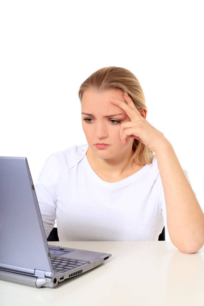 Attractive blond woman got a problem with her notebook computer. All on white background. - Foto, immagini