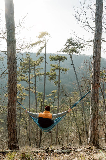 Young man resting in hammock, outdoor lifestyle - Фото, изображение