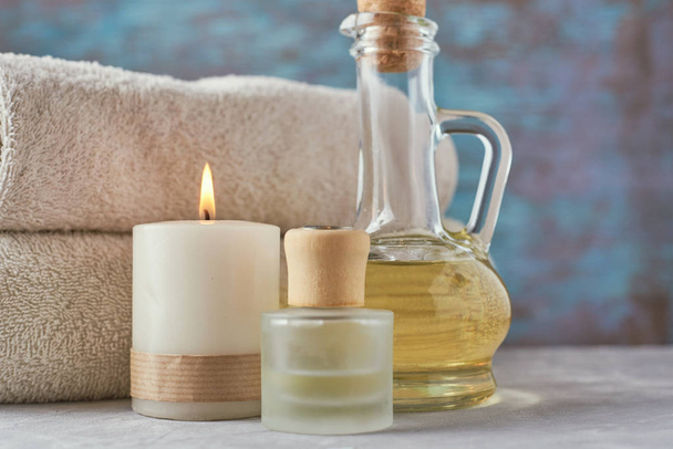 Towels, candle and massage oil on white table - Photo, Image