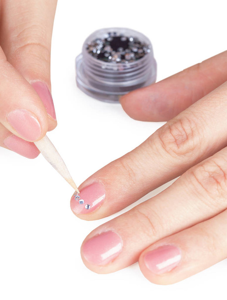Process of gluing small a paste on a nail close up - Fotó, kép