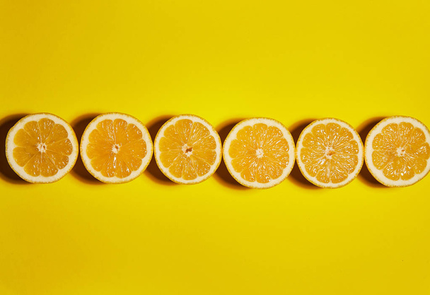 Lemon on yellow background. Flat lay, top view, copy space . Food concept. - Zdjęcie, obraz