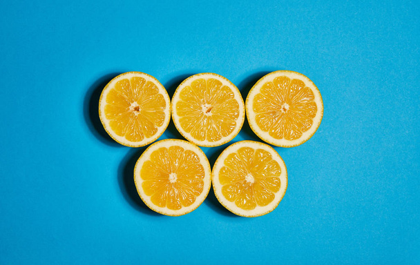 Lemon on blue background. Flat lay, top view, copy space . Food concept. - Fotó, kép