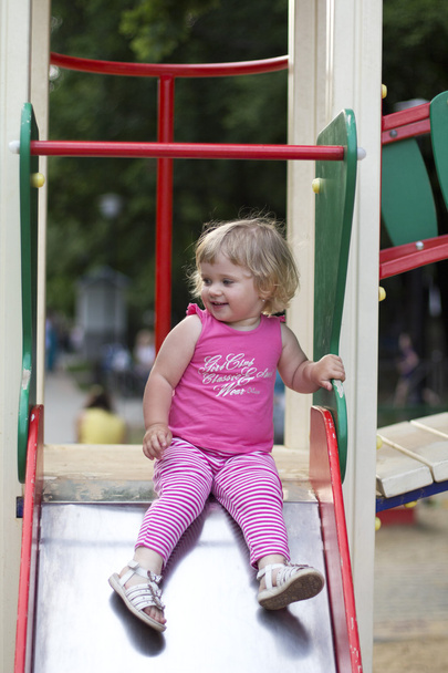 Adorable little girl having fun on a playground - Foto, afbeelding