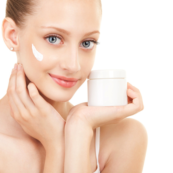Cute woman applying cream to her face - Фото, зображення