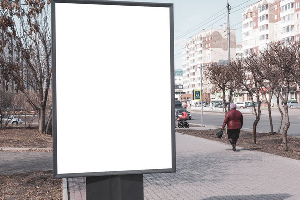 Vertical small billboard in the city on the sidewalk. Mock up for your advertising or announcements - Photo, Image