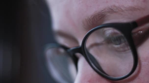 Close-up shot of woman eyes in glasses reflecting a working computer screen. - Footage, Video