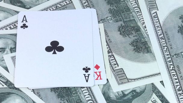 Pyörivä tausta rahaa Yhdysvaltain dollareita ja yhdistelmä kahden hengen kortteja se on pokeri lähikuva
. - Valokuva, kuva