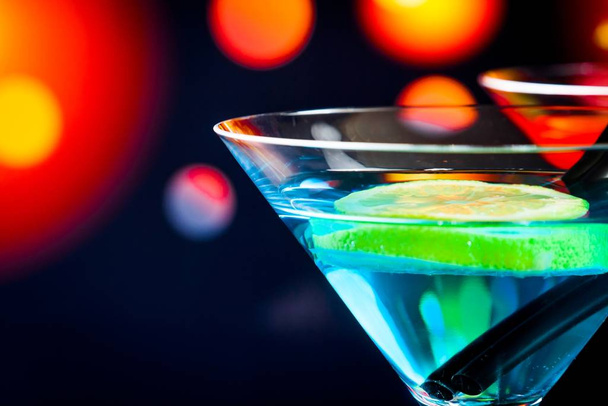 blue cocktail with light disco bokeh background with space for text, dance disco atmosphere - Zdjęcie, obraz