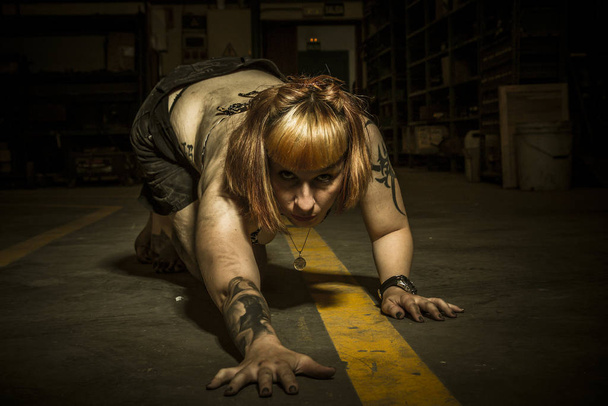 Danger, sensual woman in an industrial building - Valokuva, kuva