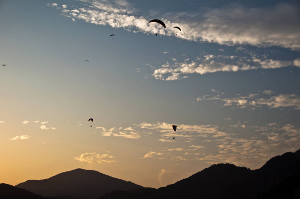Numerous paragliders above Oludeniz, near Fethiye, Turkey, in great sunset light - Foto, Imagen
