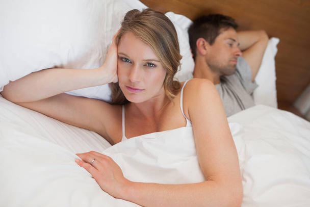 Unhappy couple not talking after an argument in bed at home - Foto, immagini