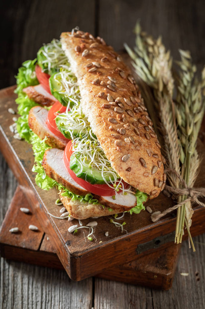Delicious sandwich with roasted chicken, lettuce and tomato - Фото, зображення