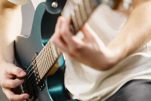 Close up of man playing on electric guitar - Foto, immagini