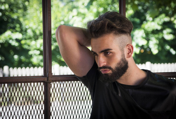 Handsome young man with beard looking to a side - Photo, image