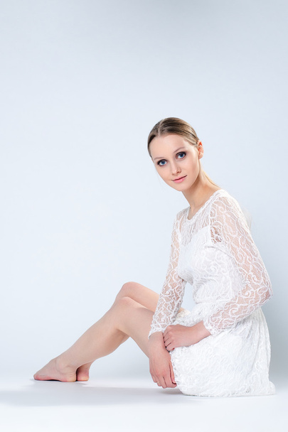 Charming woman posing in white dress - 写真・画像