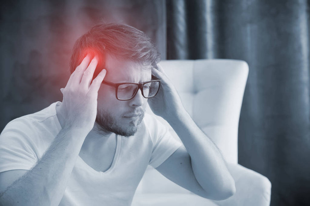 Man with a headache suffering from pain - Fotografie, Obrázek