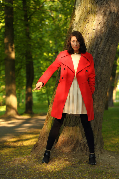 Young girl posing in red coats - Foto, Imagem