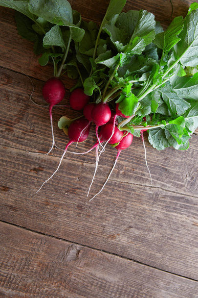 view of nice fresh radish with leafs on wooden background - Photo, Image