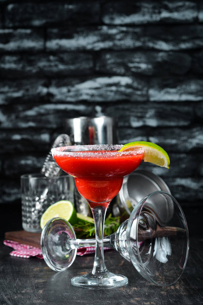 Margarita Strawberry. Alcoholic cocktail. On a wooden background. Top view. Free copy space. - Foto, Imagem