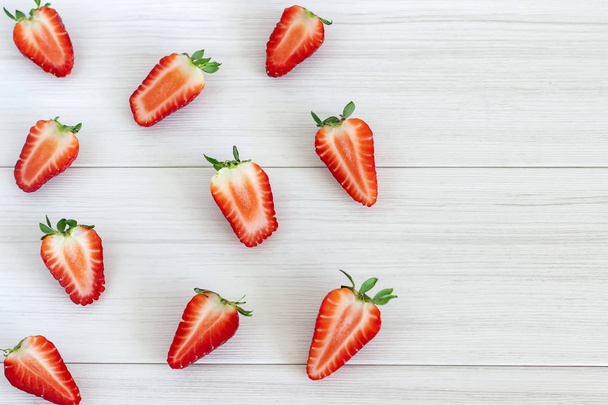 Strawberry fruits on the left side on wooden background.Top view . - Foto, afbeelding