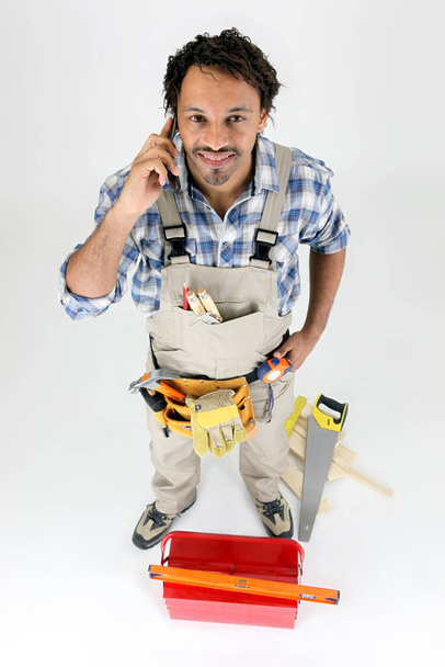 Carpenter using a telephone - Foto, Bild