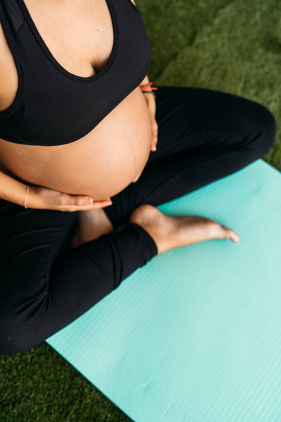 Pregnant woman doing fitness ball and pilates exercise with coac - Fotó, kép