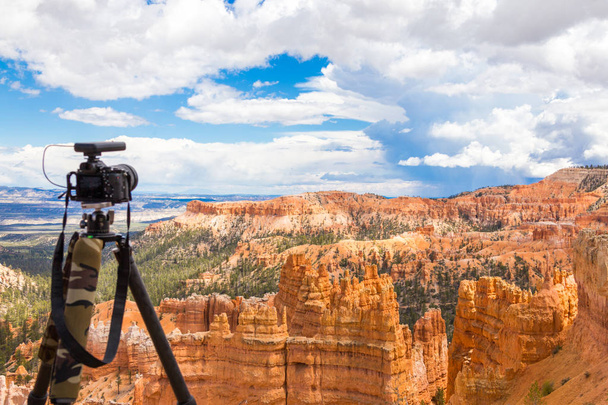 Camera on tripod ready to shoot in Bryce Canyon National Park at daytime, Utah, USA - Photo, Image