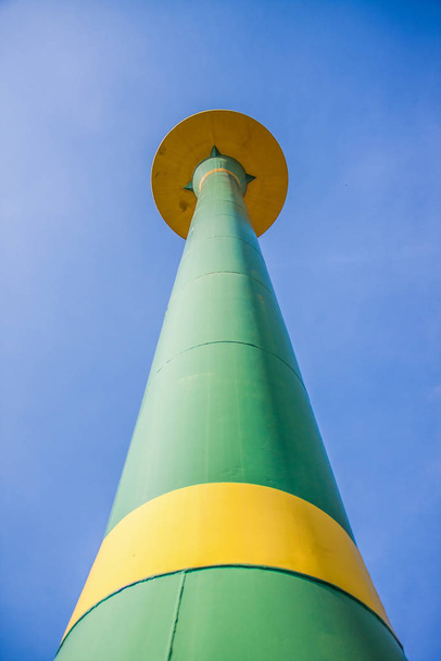 green public water tank hold up to blue sky - Fotoğraf, Görsel