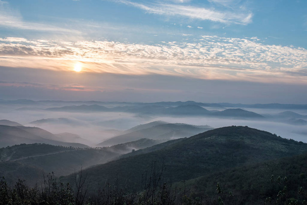 Beautiful view of the morning fog filling the valleys of smooth hills. - Φωτογραφία, εικόνα