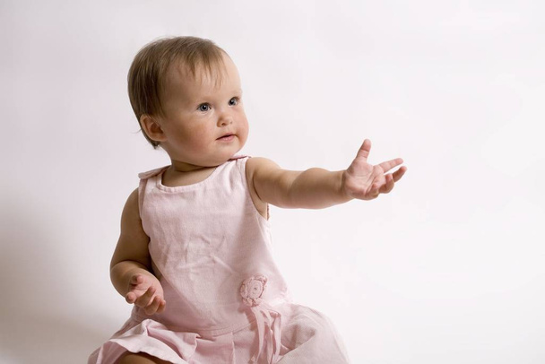 eight month baby. little girl in the pink dress - Zdjęcie, obraz