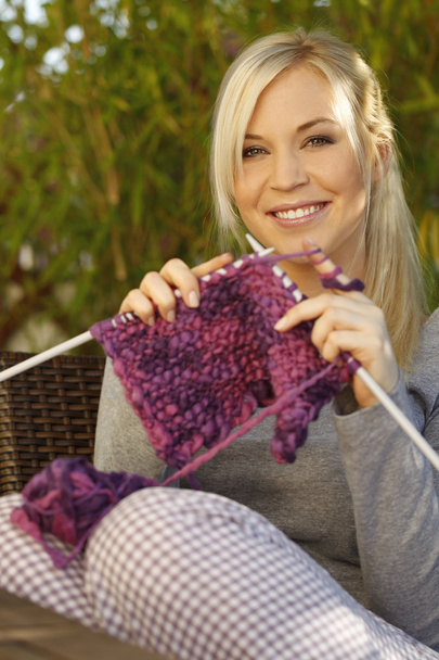 Happy woman with needlework on the terrace - Foto, Bild